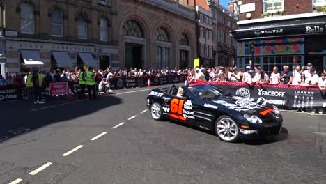 Static-wide-shot-of-fans-celebrating-car-event-in-London-in-summer
