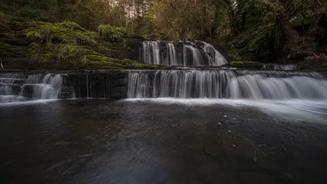 Panorama-motion-time-lapse-of-forest-waterfall-in-rural-landscape-during-autumn-in-Ireland