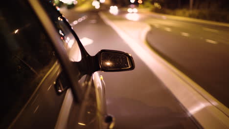 Exterior-window-shot-of-car-driving-on-pacific-highway-at-night