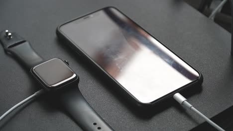 Close-up-of-an-iPhone-11-Pro-Max-and-Apple-Watch-Series-5-on-charge