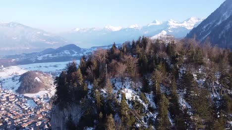 Drone-circle-around-a-small,-steep-mountain-with-lots-of-fir-trees-called-"burgfluh"-near-"Wimmis"-in-the-Bernese-Alps-in-Switzerland