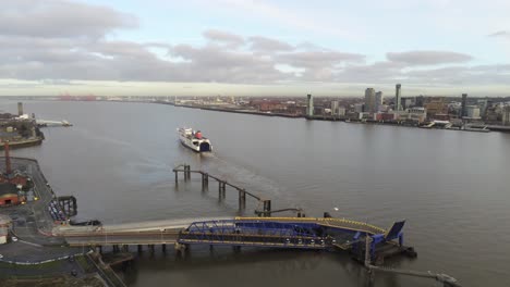 Stena-Line-logistics-ship-departing-terminal-aerial-descend-view-Birkenhead-Liverpool-harbour-city-landscape