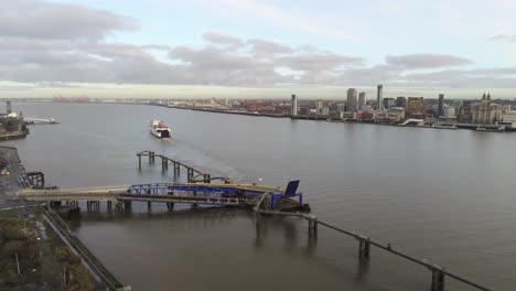 Stena-Line-logistics-ship-departs-terminal-aerial-orbit-right-view-Birkenhead-Liverpool-harbour-city-landscape