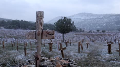 Wooden-cross-grave-while-snowing,-spiritual