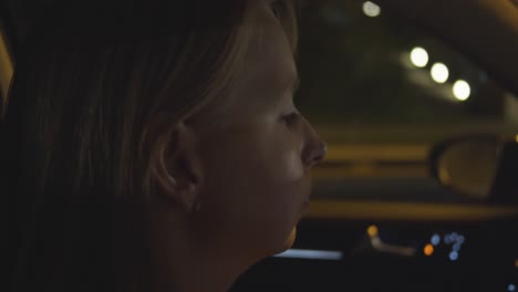Woman-drives-by-car-at-night---slow-motion