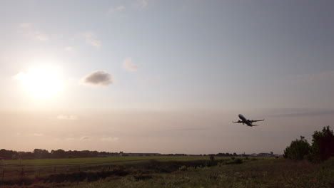 Slow-Motion-Tracking-Shot-of-Ryanair-Airplane-Departing-from-Leeds-Bradford-International-Airport-in-Yorkshire-on-Beautiful-Summer’s-Morning