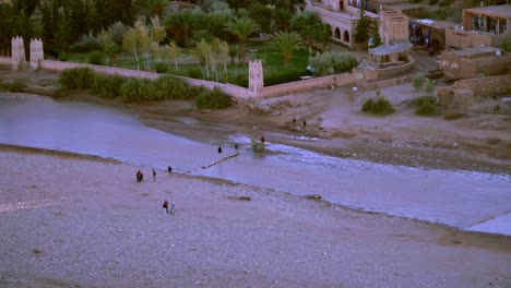 Beladener-Esel-überquert-Den-Fluss-Oued-El-Maleh-In-Der-Nähe-Des-Ait-Ben-Haddou-Denkmals-In-Marokko