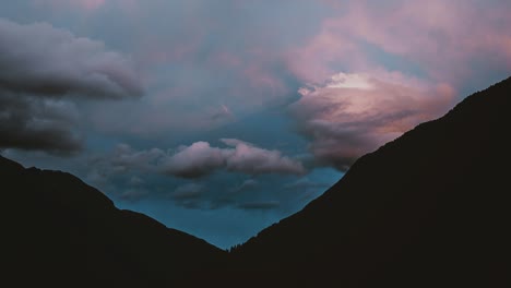 Cinemagraph-time-lapse-of-clouds-rolling-across-mountains-at-sunset