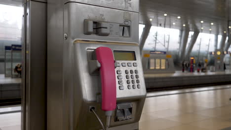 Handheld-shot-of-a-pink-payphone-at-the-Frankfurt-airport