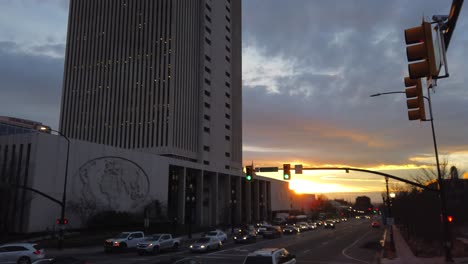 Time-lapse-of-traffic-on-state-street-downtown-Salt-Lake-City,-Utah,-with-a-sunset-and-building-of-the-LDS-church-office-building