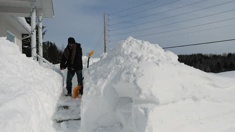 Man-doing-the-floss-dance-after-finishing-shoveling-walkway-in-front-of-snowbound-house