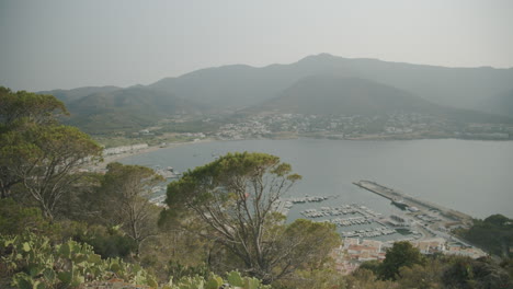 Amazing-view-on-the-El-Port-de-la-Selva-harbour-from-a-mountain-top-with-a-boat-coming-in