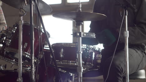 Man-playing-drums-with-band-in-abandoned-building