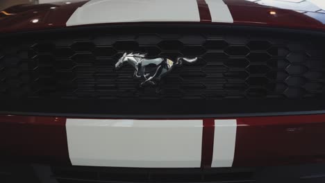 Chrome-Ford-Mustang-Grille-Logo-Emblem-on-Red-Car-with-Racing-Stripes