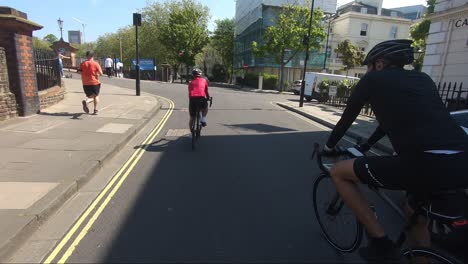 Two-Cyclists-Riding-On-Delamere-Terrace-In-Maida-Vale-During-Lockdown-In-London
