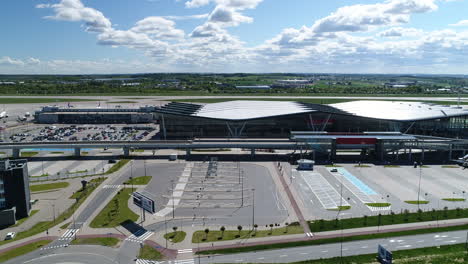 Drone-shot-of-Gdansk-airport-in-Poland-with-parking-lots-in-front-of-it