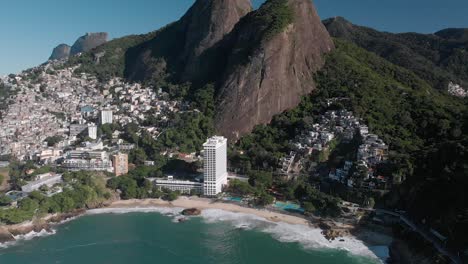 Steady-aerial-view-on-Vidigal-beach-with-the-shanty-town-community-on-the-slopes-of-the-Two-Brothers-mountain-and-Gavea-mountain-top-in-the-background