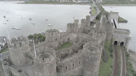 Medieval-landmark-historic-Conwy-castle-aerial-view-above-Welsh-seaside-landscape-orbit-right