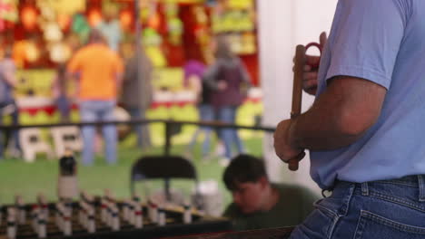 Man-playing-ring-toss-game,-Medium-Shot,-Over-the-Shoulder,-Slow-Motion