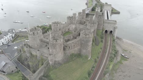 Medieval-landmark-stronghold-Conwy-castle-aerial-view-above-Welsh-attraction-landscape-wide-orbit-right