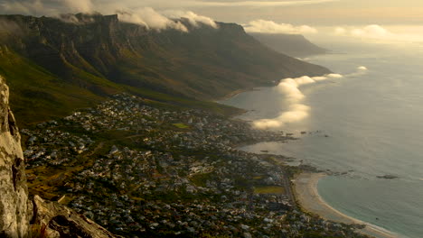 TimeLapse---Awesome-cloud-formations-over-mountains-and-mist-flowing-in-from-ocean,-Camps-Bay,-South-Africa
