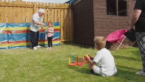Grandparents-having-fun-playing-games-with-grandchildren-in-the-backgarden-during-summertime