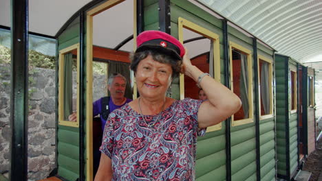Shot-old-lady-wearing-the-train's-captain-hat-in-Arenal-national-park---Costa-Rica
