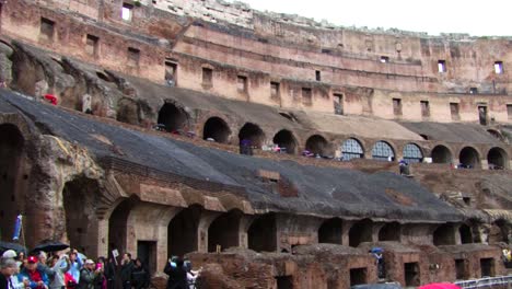 Groups-of-tourists-visiting-The-Colosseum-inside,-Rome,-Italy