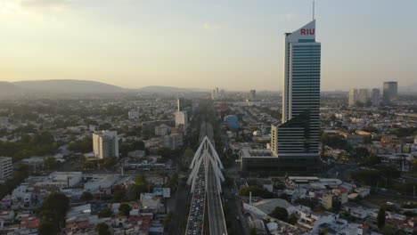 Bird's-Eye-View-Above-Highway-Bridge,-Modern-Riu-Hotel-Building-in-Background-4K