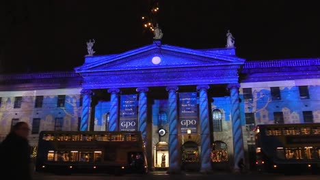 General-post-office-with-people-and-public-transport-at-night-time-December-1st