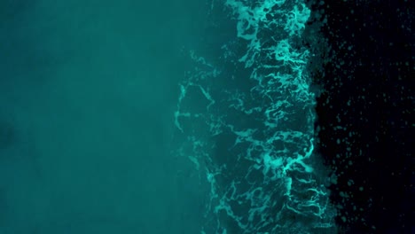 Turquoise-Blue-Sea-With-Waves-Splashing-On-The-Shore---aerial-drone,-top-down-shot