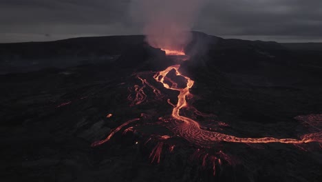 Aerial-view-overlooking-lava-rivers-at-a-volcano-basin---circling,-drone-shot