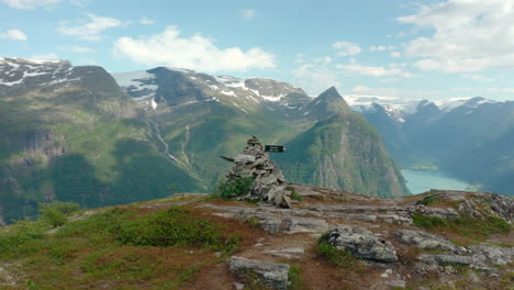 Pile-Of-Rocks-At-The-Summit-Of-The-Mountain-Overlooking-The-Oldeelva-River-At-The-Valley-Of-Oldedalen-In-Olden,-Norway