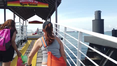 2-women-carrying-things-and-entering-Kusu-Island-in-Singapore