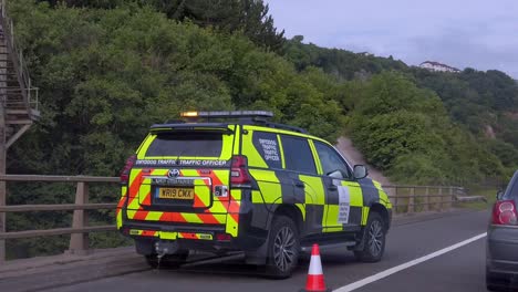 Driving-slow-Welsh-highway-road-traffic-accident-police-patrol-car-blockade-on-motorway