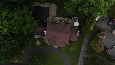 Aerial-Top-down-Drone-Footage-Rising-and-Turning-Over-a-Large-House-in-a-Luxury-Neighborhood