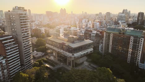 Aerial-establishing-shot-of-National-Library-with-buildings-and-sunset-behind