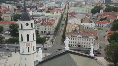 AERIAL:-People-Walking-In-Streets-near-Vilnius-Cathedral-Bell-Tower-and-Gediminas-Avenue