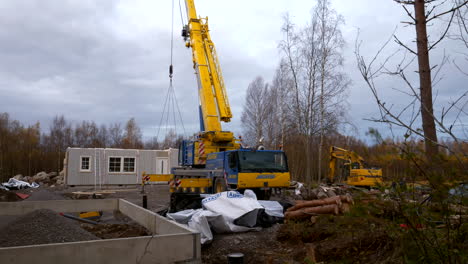 Crane-machine-lifting-panels-for-construction-of-new-prefabricated-house-in-rural-area