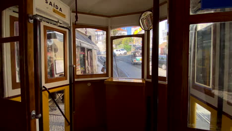 Vintage-tram-tour-in-Lisbon---the-interior-of-an-oldfashion-antique-tram-with-wooden-coating---city-streets-on-background
