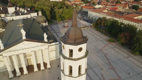 AERIAL:-Reveal-Shot-of-Vilnius-Cathedral-and-Bell-Tower-in-Summer-with-People-in-Background