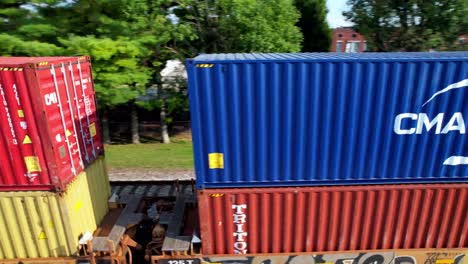 Freight-train-aerial-on-tracks-in-cave-city-kentucky,-box-cars-on-tracks