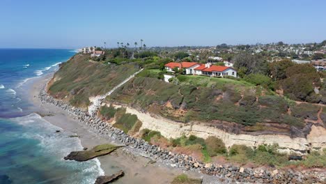 Drone-shot-flying-towards-beachfront-houses-on-the-coast-of-California,-America
