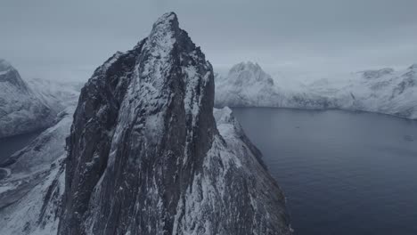 Aerial-view-close-around-the-Segla-mountain,-gloomy-winter-day-in-Senja,-North-Norway---circling,-drone-shot