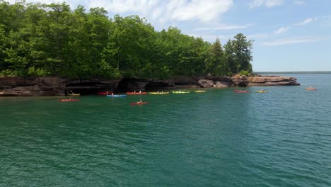 Aerial-view-of-Kayakers-on-a-summer-afternoon-at-Lake-Superior,-Madeline-island-Big-bay-state-park-at-the-Apostle-island