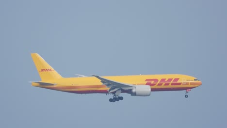 DHL-cargo-jetliner-descending-and-preparing-to-land-in-airport,-motion-view