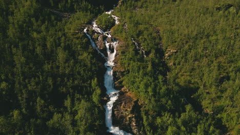 Aerial-Of-River-On-Steep-Slopes-Hills-Flowing-In-Between-Lush-Trees-In-Finnmark,-Norway