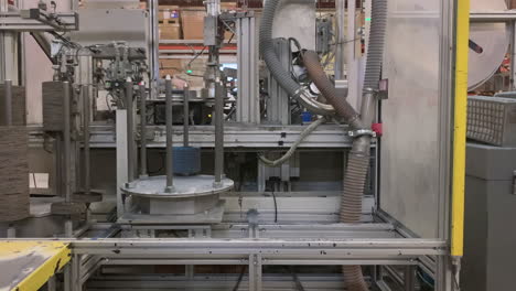 Low-angle,-static,-time-lapse-of-a-production-machine-making-flap-disks
