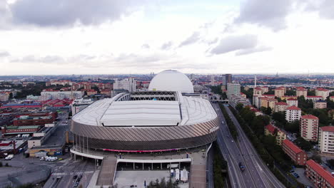 Stockholm-city-and-majestic-arena-building-of-Tele2,-aerial-orbit-view