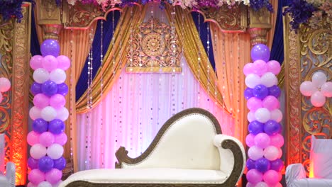 decoration-of-balloons-around-white-sofa-couch-in-center-of-stage-ceremony-wedding-party-birthday